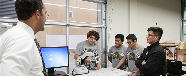 Teacher with robotics team