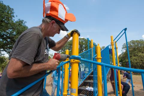 Contractor installing playground